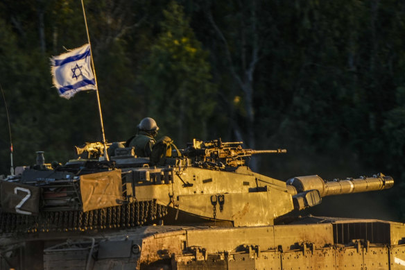 An Israeli tank moves along the Israel Gaza border on Thursday.