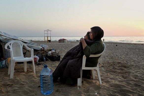 Ferial hugs her daughter Israa, 10, outside their makeshift tent where they are living with six other family members on Ramlet al-Baida Beach in Beirut. The Syrian refugees have relocated here from Dahiyeh in Beirut’s south.