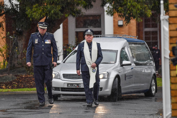 Victoria Police chief commissioner Graham Ashton (left) led the funeral procession after Glen Humphris was farewelled by his partner and family on Friday.