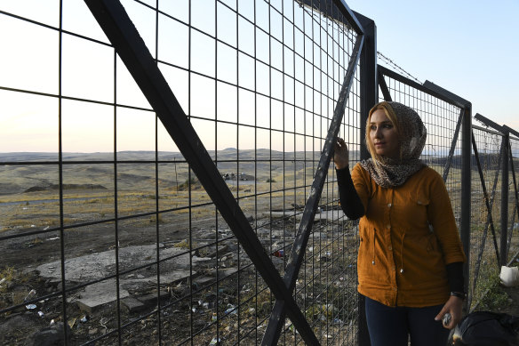 Amina Abdulkhaleq, 25, looks out at the Syria-Iraq border from the relative safety of an Iraqi receiving centre for refugees.