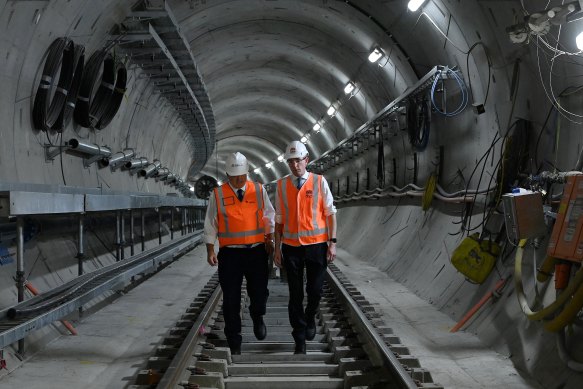 NSW Premier Dominic Perrottet (right) and NSW Minister for Transport David Elliott walk along the final track of the Sydney Metro City at the Martin Place Metro station on Wednesday.