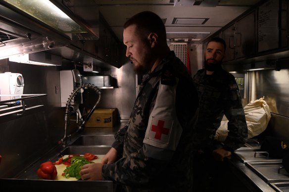 Submariners in the kitchen onboard the HMAS Rankin. Without exercise, putting on weight is a hazard. 