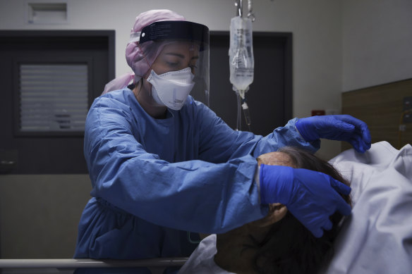 St Vincent's nurse Talyna Smith cares for a suspected COVID-19 patient in an isolation room.