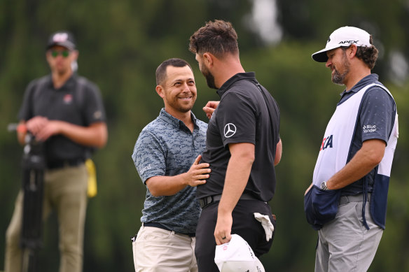 Xander Schauffele is congratulated by world No.2 Jon Rahm after his opening round.
