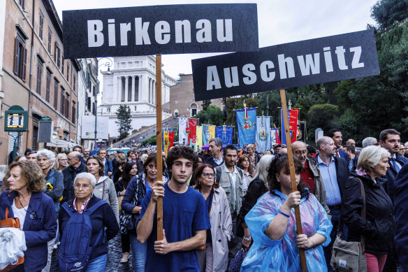 People participate in a march of remembrance marking the 80th anniversary of the round-up of the Jews of Rome in Rome on Monday.