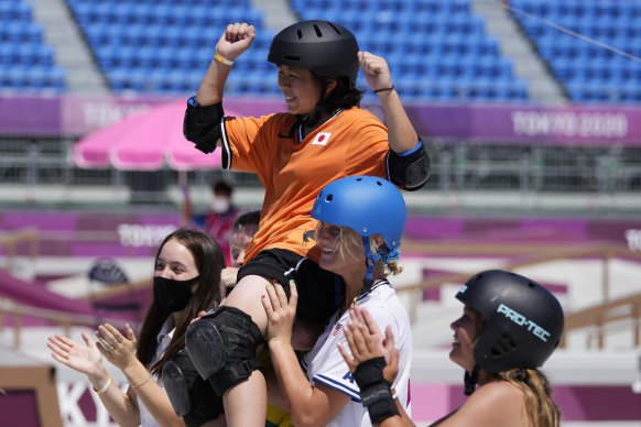 Japan’s Misugu Okamoto being helped by her fellow competitors.