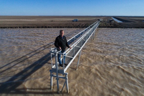 Ian Cole, a former owner of Darling Farms and now a member of irrigator groups, stands on a platform over one of the farm's storages near the NSW town of Bourke.