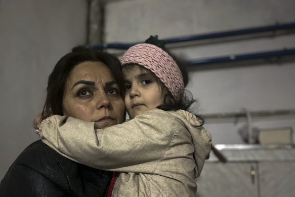 A girl embraces a family member in a shelter during shelling in Stepanakert, Nagorno-Karabakh.