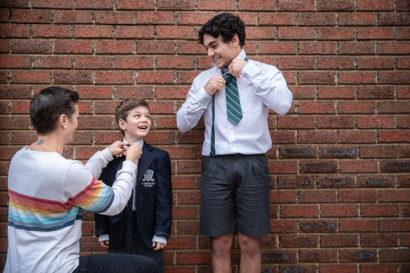 Georgia Gregg helps son Ned, 6, and stepson Harry, 17, prepare to return to school.