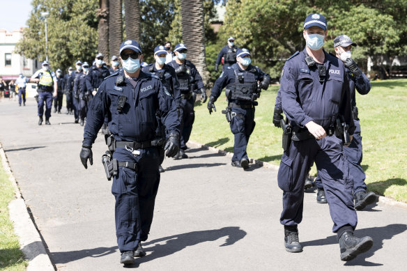 The riot squad walks through Victoria Park next to the Sydney University campus.