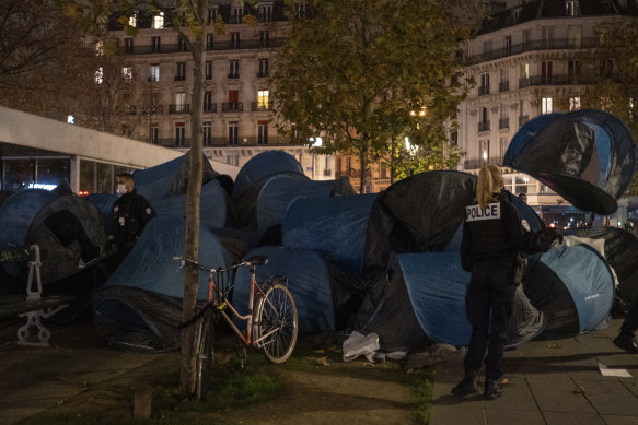 Paris police are under government orders to explain themselves after officers were filmed tossing migrants out of tents while evacuating them.