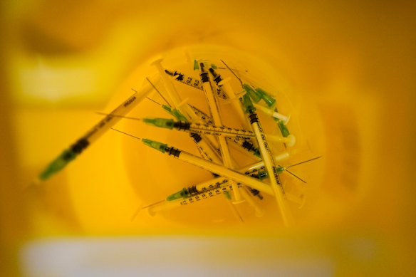 Used syringes in a bin at a vaccination centre in London.