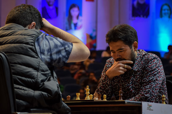 Nakamura (right) ponders his next move during a 2022 match with Iran’s Parham Maghsoodloo.