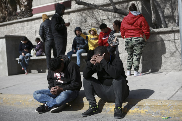Migrants grieve in front at a Mexican immigration detention centre on Tuesday.