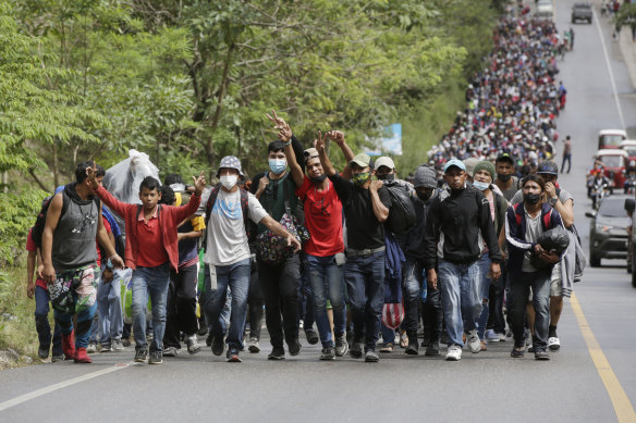 Migrants enter Guatemala after breaking a police barricade at the border checkpoint on January 16, 2021 in El Florido, Guatemala. 