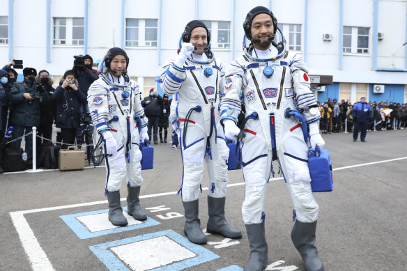 Roscosmos cosmonaut Alexander Misurkin, center, and spaceflight participants Yusaku Maezawa, left, and Yozo Hirano, right, of Japan, members of the main crew of the new Soyuz mission to the International Space Station  in December 2021.