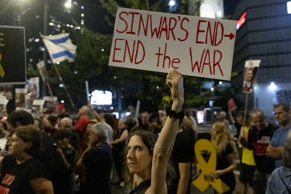 A protester in Tel Aviv calls for a hostages deal after the death of Yahya Sinwar. 