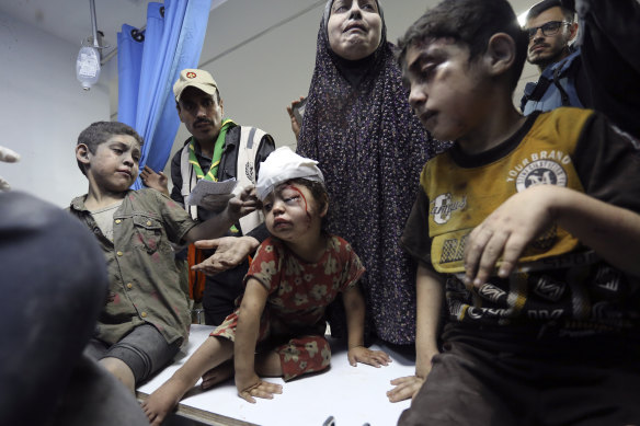 Wounded Palestinians arrive at the al-Shifa hospital, following Israeli airstrikes on Gaza City.