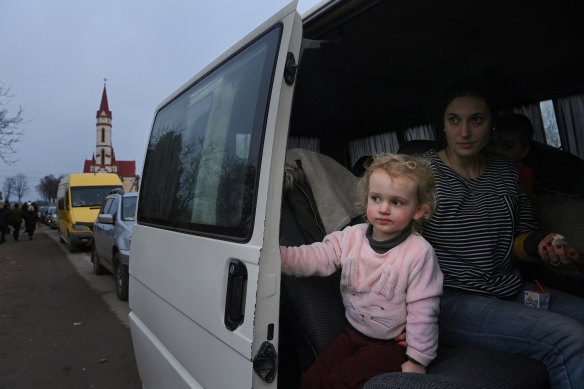 Maria and her family near the border crossing with Poland. They have been on the road for four days. 