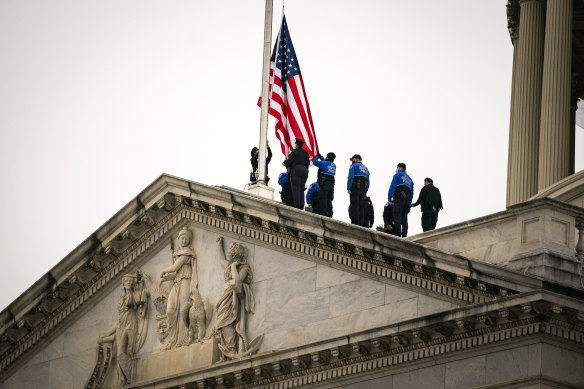 US Capitol Police lower the American flag at the US Capitol in Washingtonto mark the death of Capitol Police Officer Brian Sicknick.