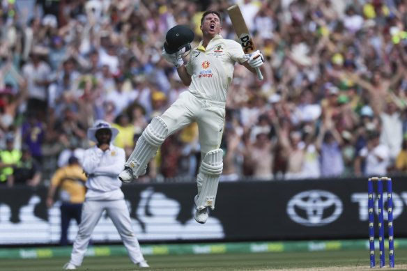 David Warner leaps in celebration after reaching 200. He retired hurt after seizing up with cramp shortly afterwards.