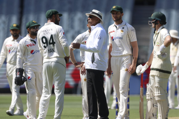 Pakistan’s Shan Masood, third left, talks with umpire Joel Wilson after losing a review for an Australian wicket.