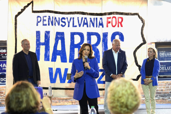 Vice President Kamala Harris speaks, watched by running mate Tim Walz (second from right) at a campaign event in Pennsylvania in August.