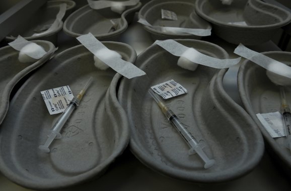 Trays holding needles and swabs in preparation for the AstraZeneca COVID-19 vaccinations at Tharawal Corporation Medical Centre in Airds, in Sydney.