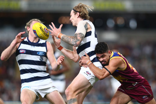 Brisbane Lion Charlie Cameron tackles Geelong’s Tom Stewart at the Gabba on Thursday night.