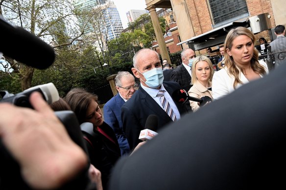 Chris Dawson (centre) arrives at the NSW Supreme Court for the announcement of his verdict on August 30.