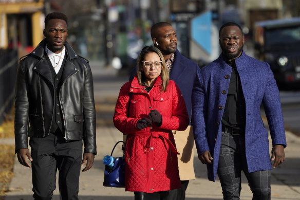 Lawyer Gloria Schmidt Rodriguez, centre, walks with clients Abimbola Osundairo, left, and Olabinjo Osundairo as they testify in the trial of actor Jussie Smollett on Thursday. (A bodyguard walks behind Rodriguez).