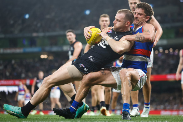 Sam Docherty is tackled by Tom Liberatore