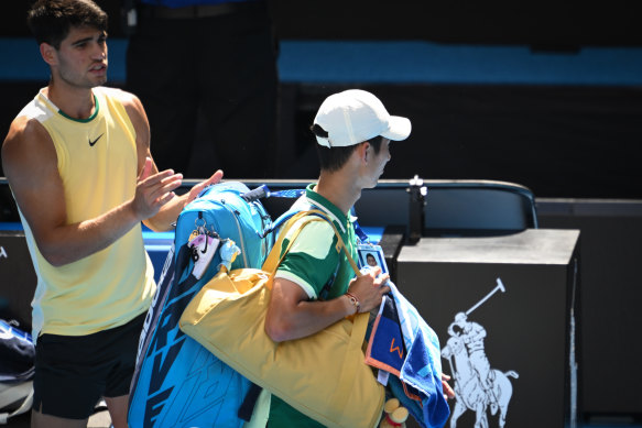 Alcaraz applauds Shang as he leaves Rod Laver Arena.
