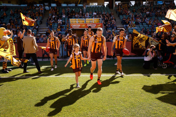 Hawthorn players take the field for the clash with the Crows.