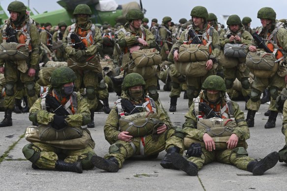 Russian paratroopers wait to be loaded into a plane for airborne drills on Thursday.