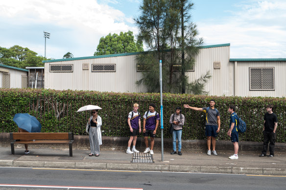 Commuters at a bus stop on Parramatta Road in Camperdown.