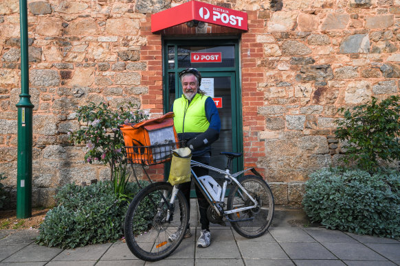 Postie Dave outside the Yackandandah post office on his electric bike. 