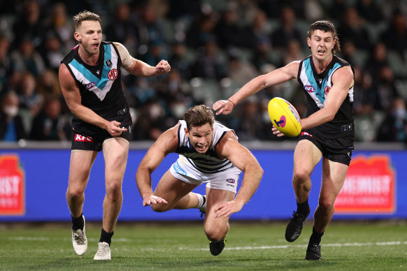 Trent McKenzie and Darcy Byrne-Jones compete for the ball with Geelong’s Tom Hawkins.