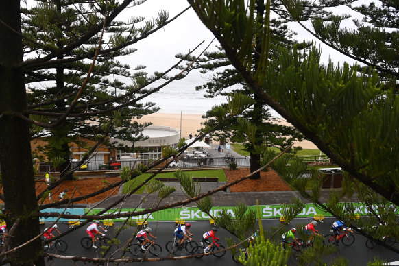 Riders in the under-19 road race travel along the coast in Wollongong on Friday.