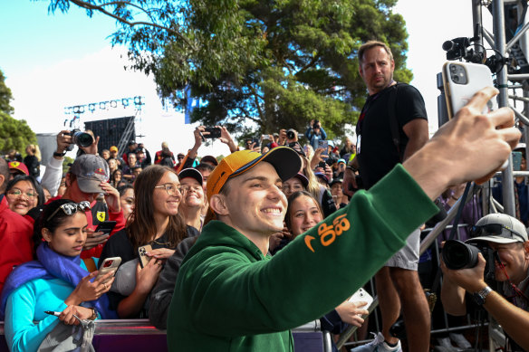 Oscar Piastri takes selfies with fans at Albert Park on Thursday.