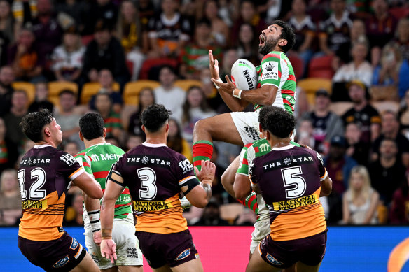 Alex Johnston leaps to catch a high ball.