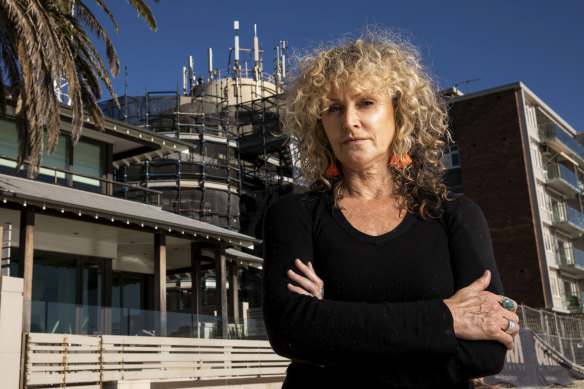 Anti-5G campaigner  Mercy Wolf in front of a 5G installation in Sydney.