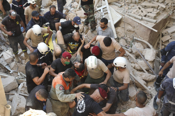A survivor is taken out of the rubble after a massive explosion in Beirut on Wednesday. 