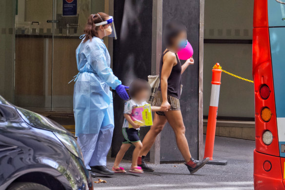 Guests are removed from the Holiday Inn on Flinders in response to the COVID-19 outbreak in February. 