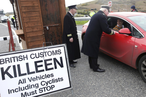 Men dressed as British customs officers stop traffic during an Irish anti-Brexit spoof on the Old Dublin Road at Carrickarnon, near the border with Northern Ireland.