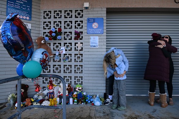 Families at a vigil for the dead boy at Wyong on Monday.