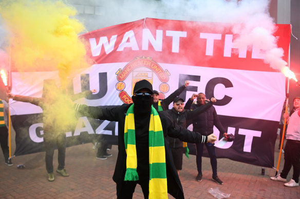 A fans wearing Manchester United’s green-and-gold formation colours outside Old Trafford on Sunday.