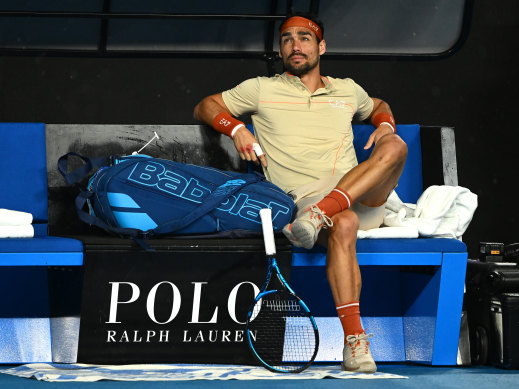 Italian Fabio Fognini waits out the rain during his suspended match against Thanaski Kokkinakis.