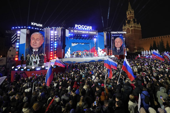 Russian President Vladimir Putin is displayed on huge screens at a Red Square concert marking his election win and the 10-year anniversary of Crimea.