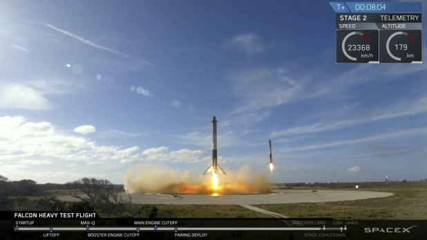 Two booster rockets land at Cape Canaveral during the first test flight of the Falcon Heavy rocket.